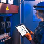 woman engineer checks electrical panel using digital schematic technical inspection